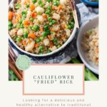 a bowl of cauliflower "fried" rice with carrots and peas