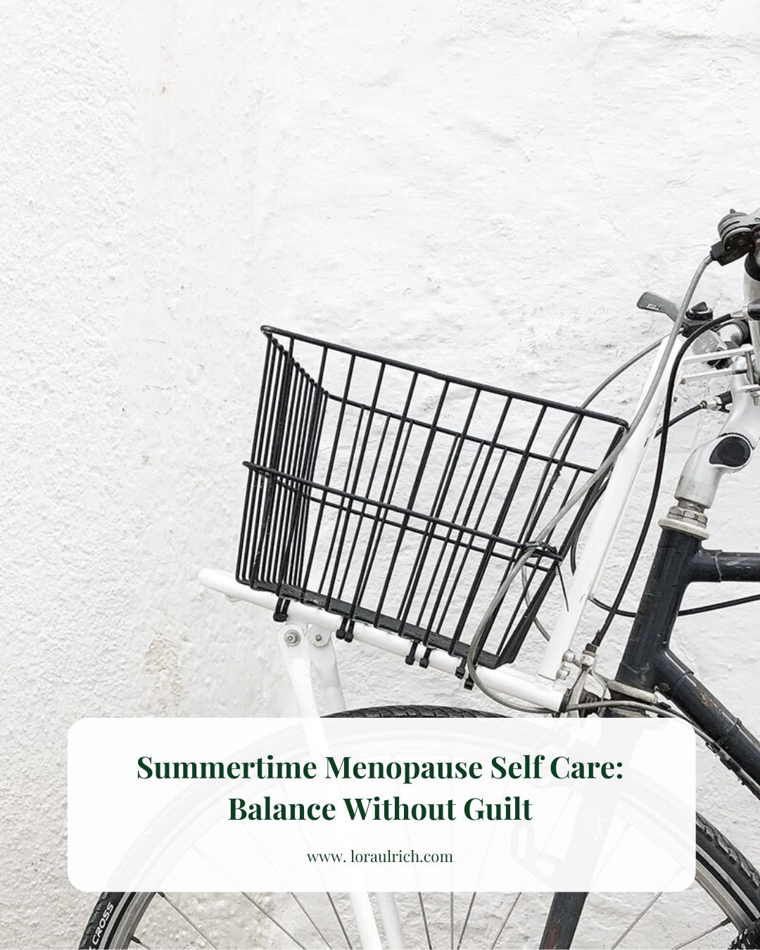 Minimalist shot of a bicycle with a front basket against a white wall, perfect for menopause self-care ideas.