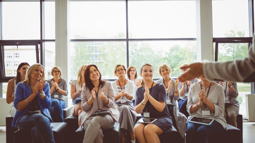 group of women clapping for social support and connection