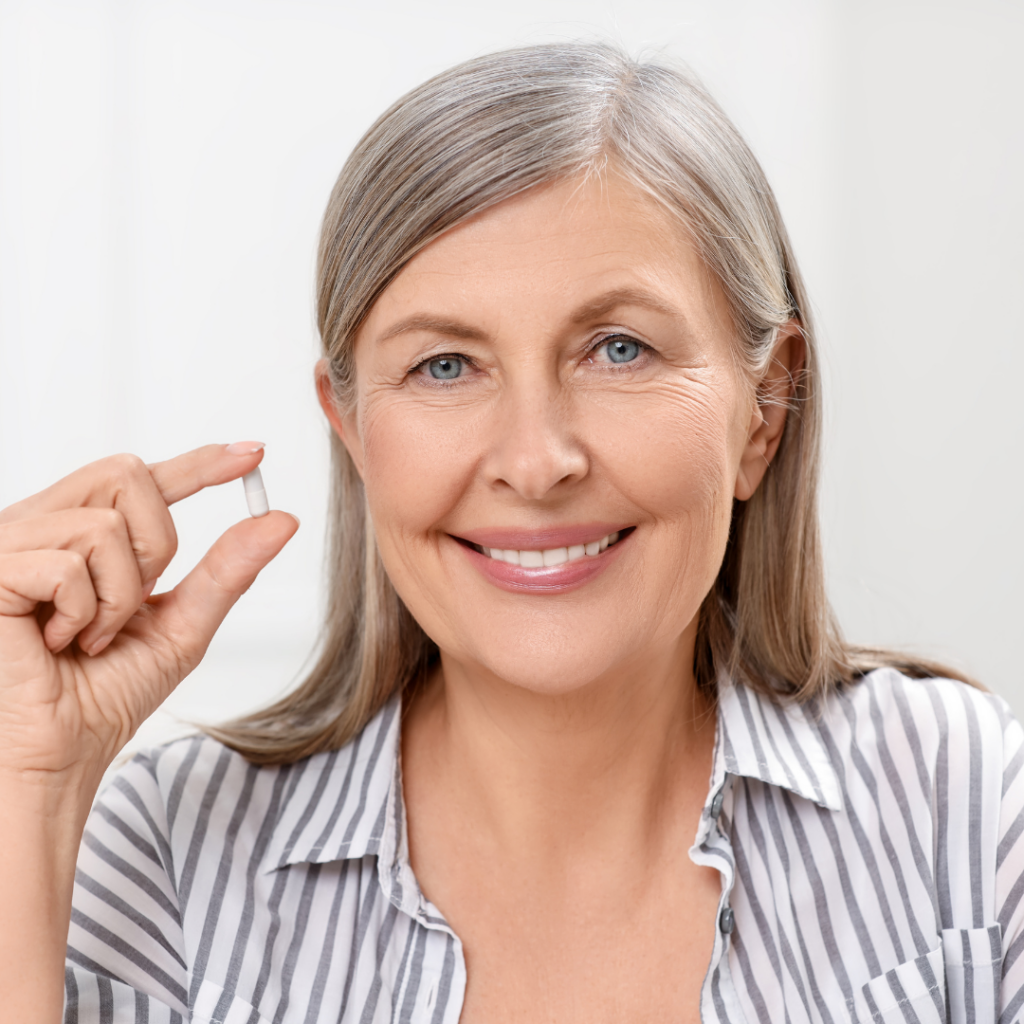 woman holding supplements to reduce menopause belly