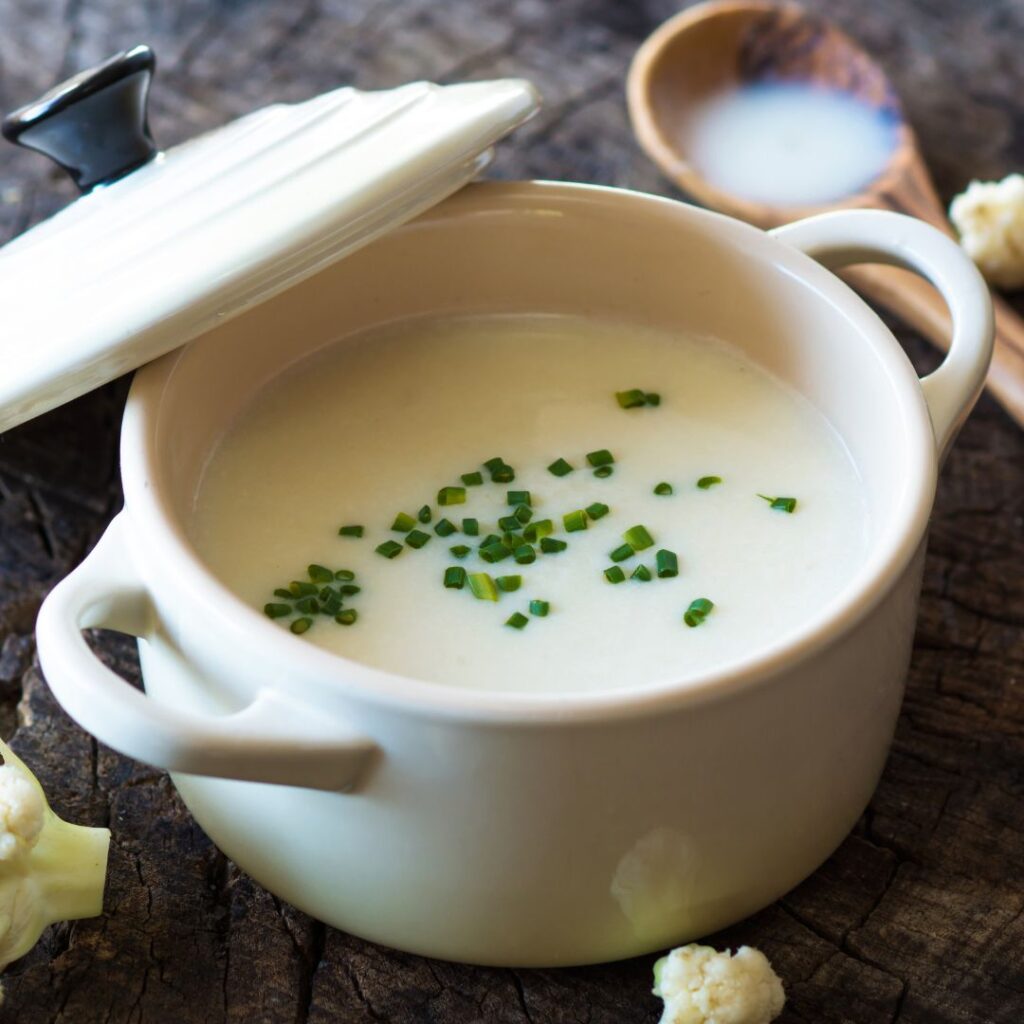 Creamy cauliflower soup made with coconut milk, served in a bowl, dairy-free and hormone-friendly comfort food.