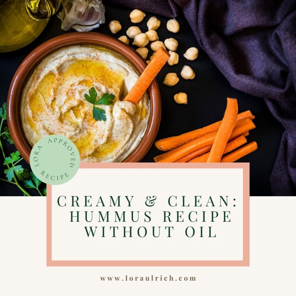 Creamy homemade hummus without oil, served in a bowl and garnished with paprika and parsley, surrounded by sliced carrots