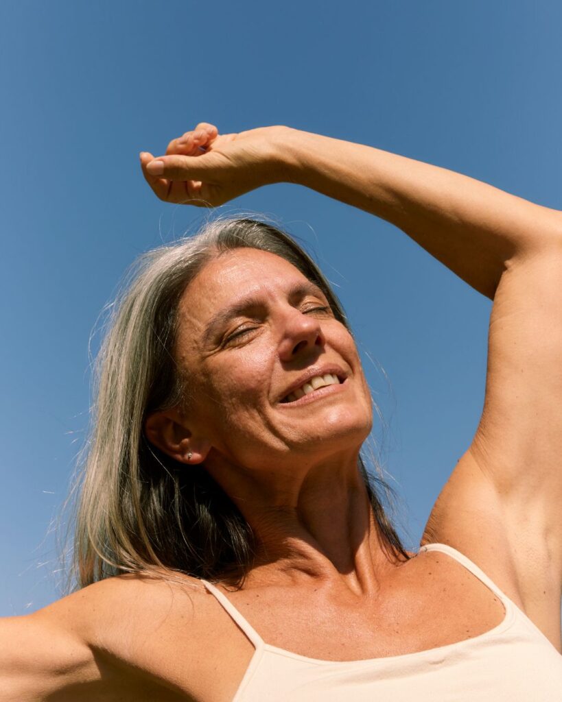 Midlife woman radiating confidence and vitality, symbolizing empowerment offered through menopause health coaching