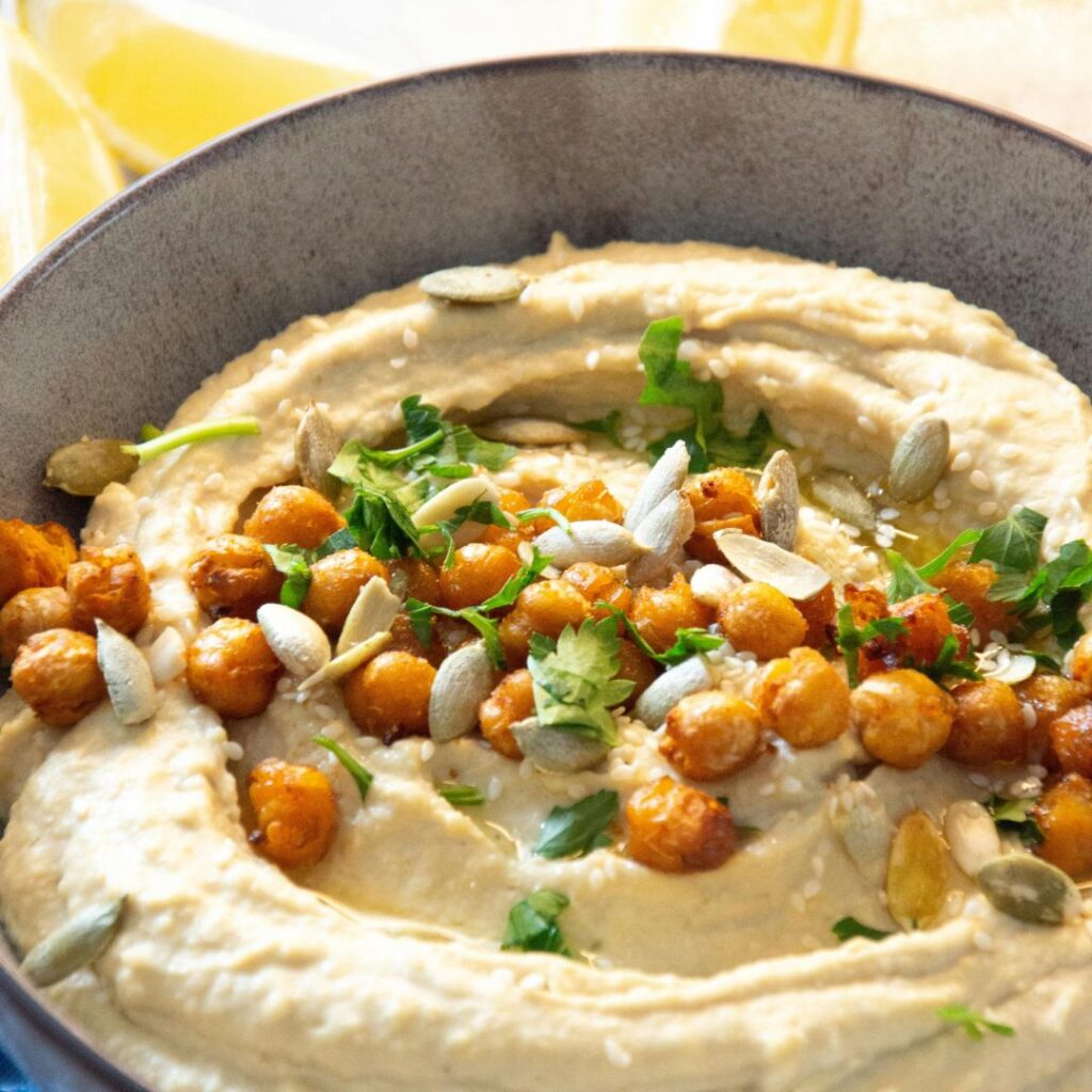 Creamy homemade chickpea hummus without oil, served in a bowl.
