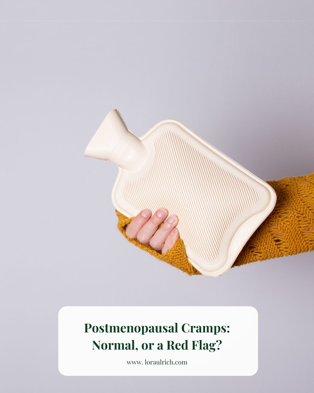 A woman's hand gently holding a heating pad, symbolizing comfort and relief from postmenopausal cramps.