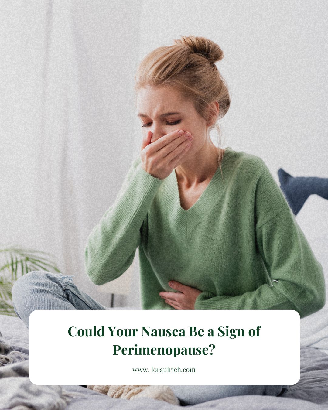Woman holding her stomach with a pained expression, seated quietly and appearing queasy, capturing the discomfort of perimenopause nausea.