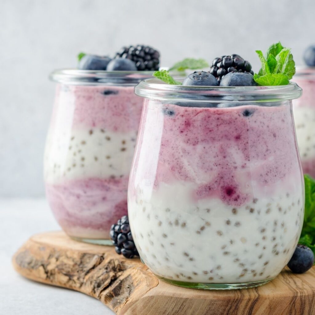 Dairy-free blueberry chia pudding served in a glass jar topped with fresh blueberries and mint.
