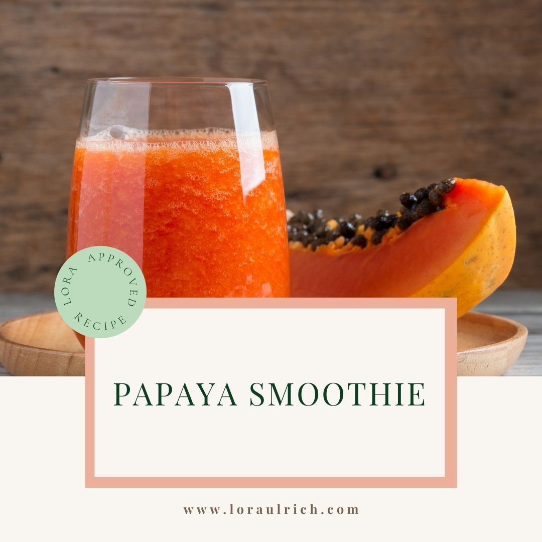 Creamy papaya smoothie made with almond milk and fresh papaya cubes, styled as a nourishing drink for digestion and menopause support.