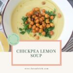 Creamy golden chickpea lemon soup topped with crispy chickpeas, fresh parsley, and a drizzle of olive oil in a white bowl.