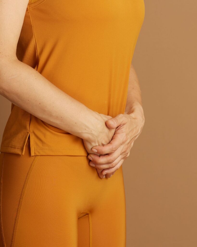 A woman experiencing perimenopause water retention and abdominal bloating, seeking holistic metabolism support.