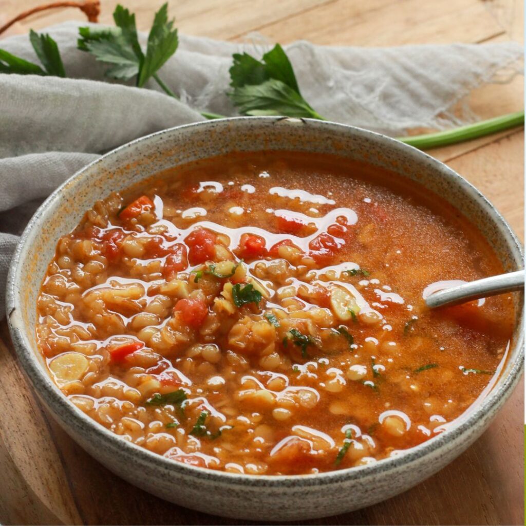 Hearty lentil quinoa soup served warm, rich in plant protein and fiber. A fast metabolism diet recipe for midlife health.