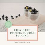 A glass filled with creamy chia seed pudding with blueberries on top.