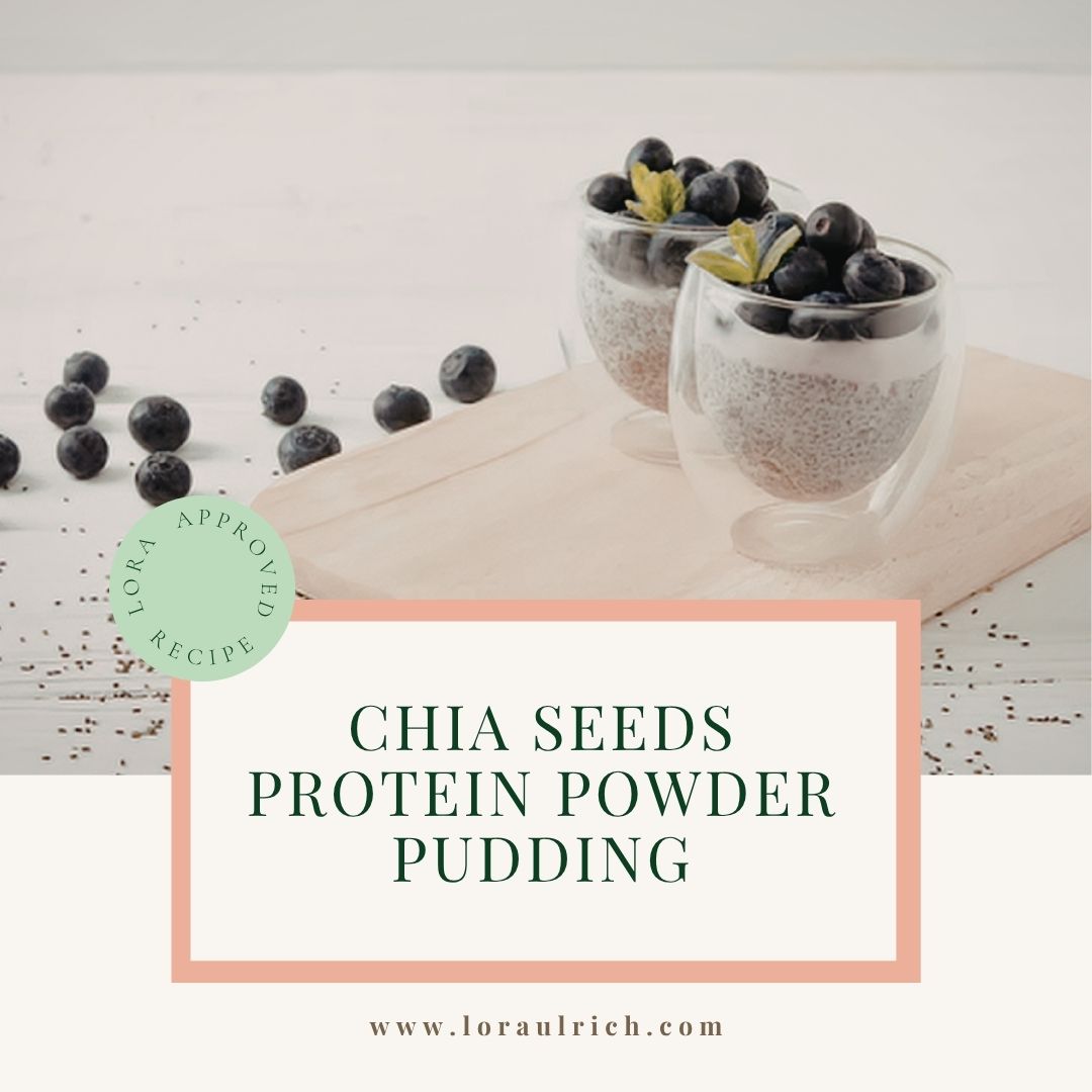 A glass filled with creamy chia seed pudding with blueberries on top.