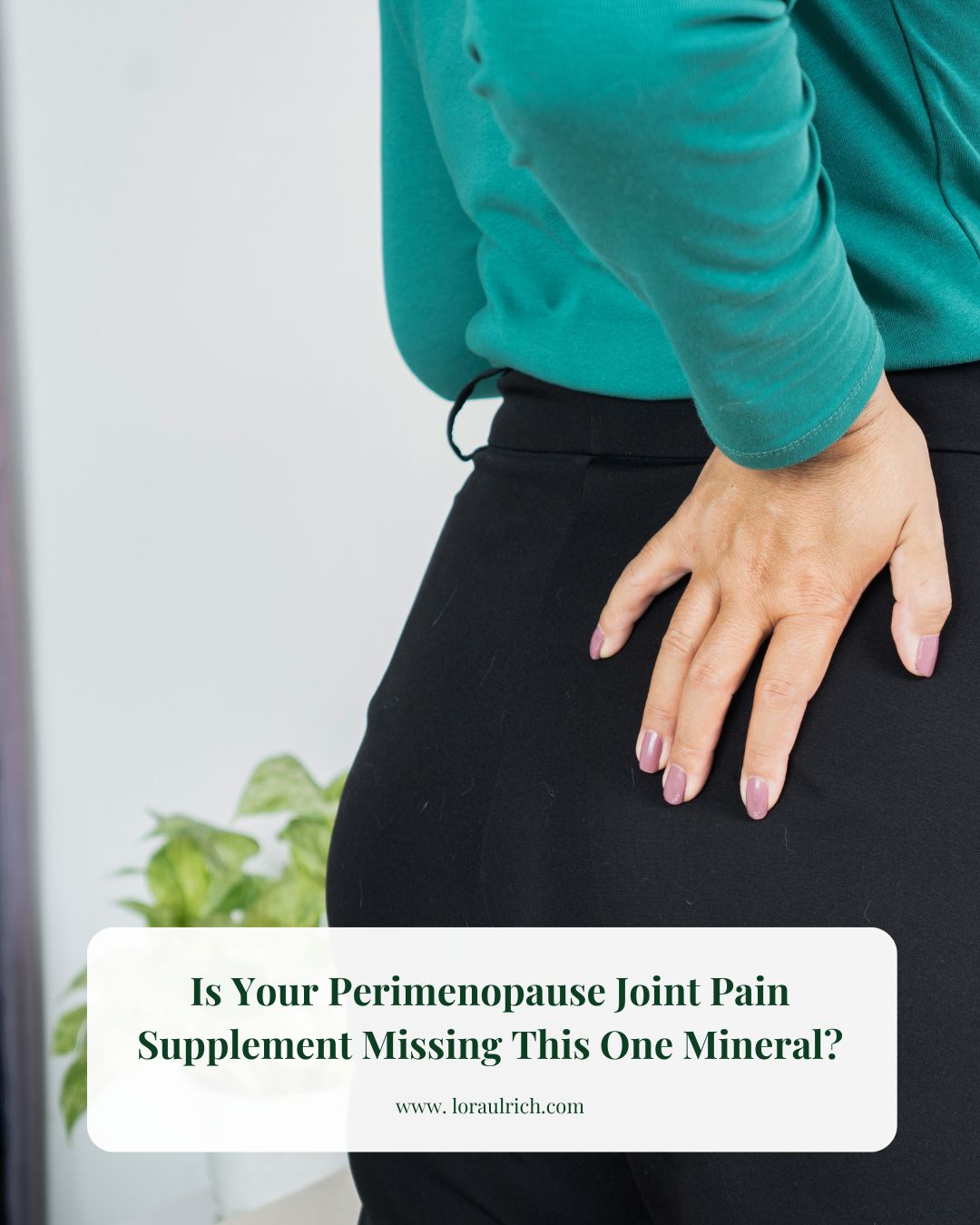 A midlife woman in green shirt holding her lower back and hip joint in discomfort, illustrating perimenopause joint pain and stiffness.