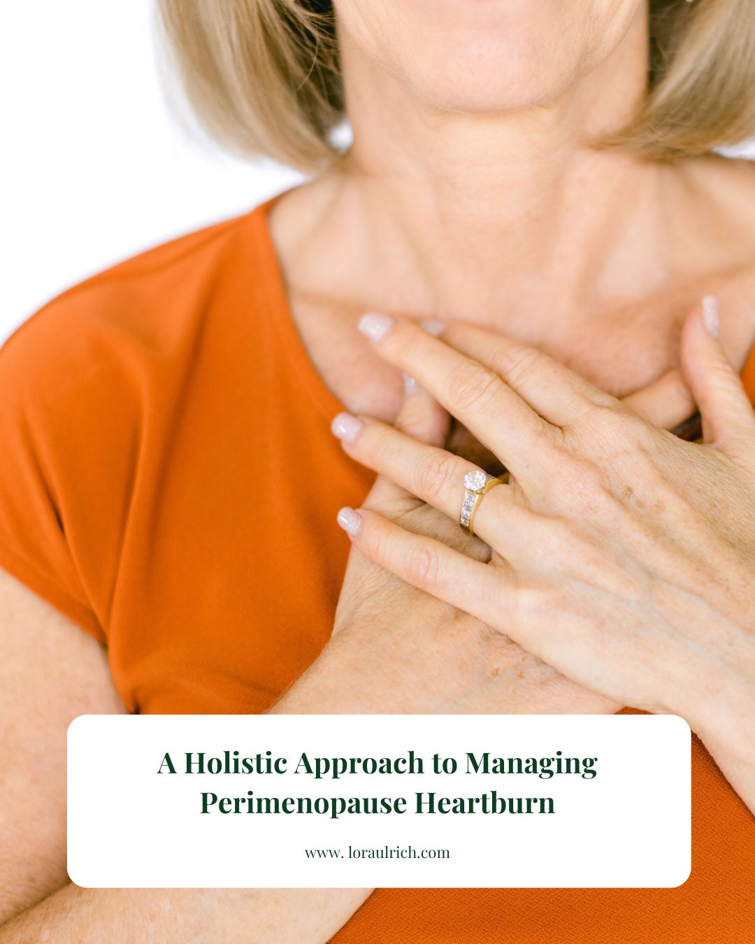 A woman in an orange top holding her hands to her chest to illustrate the common discomfort of perimenopause heartburn.