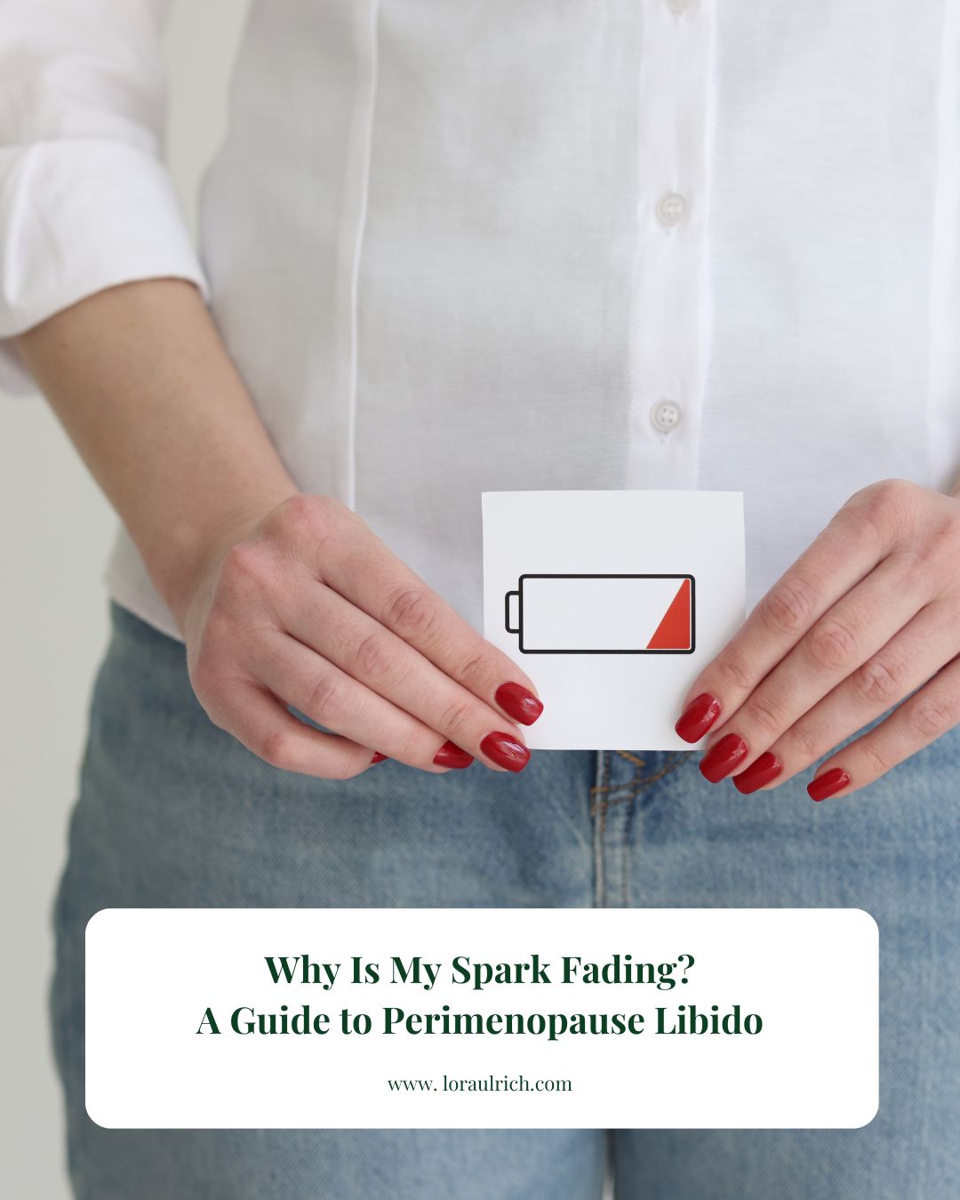 A woman holding a card with a low battery icon, symbolizing the hormone fatigue and low perimenopause libido addressed in this blog.