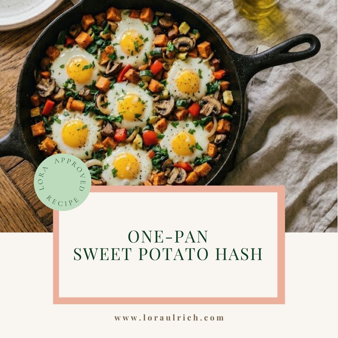 A cast iron skillet on a wooden table filled with a healthy sweet potato hash made of spring vegetables and crispy eggs.