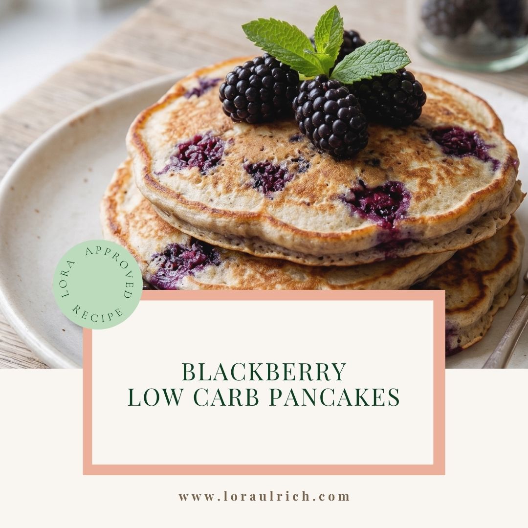 Stack of fluffy low carb pancakes made with almond flour and protein powder, topped with fresh blackberries and mint sprigs, ideal for midlife health.
